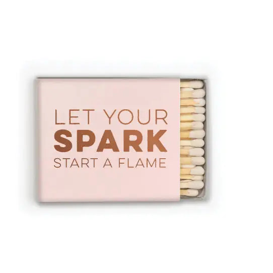 Matchbox with 'Let Your Spark Start a Flame' text on a white background
