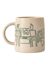 beige mug with a green illustration of a kitchen interior