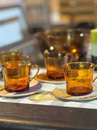 Amber glass cups on a table with a blurred background