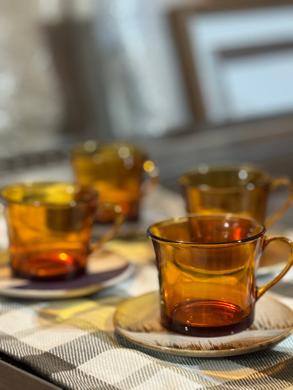 Amber glass cups on a checkered tablecloth with a blurred background