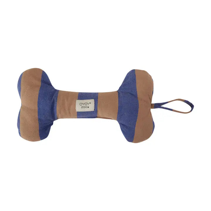 A bone-shaped dog toy made of striped fabric in tan and blue, with a small white label reading 'OYOY ZOO' in the center and a matching blue loop at the end, shown on a plain white background.