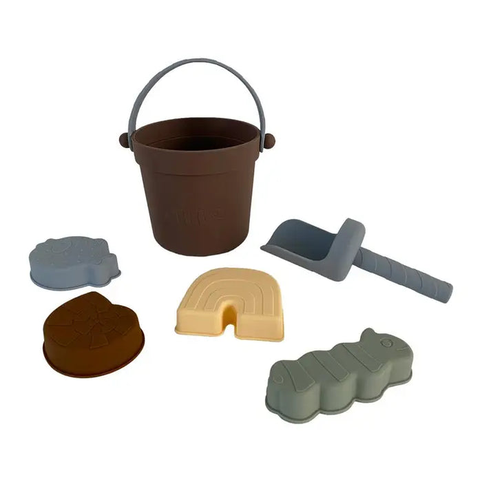 Set of children's sand toys including a bucket, mold shapes, and a roller on a white background