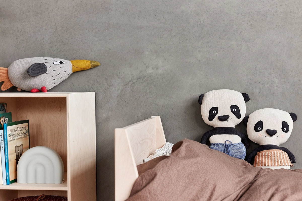 panda bear in bed with other stuffed animals