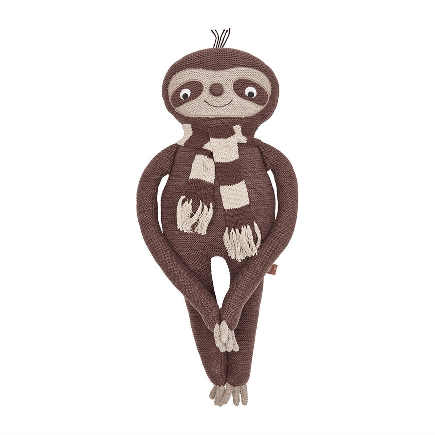 Knitted sloth toy with a checkered scarf on a white background