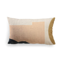 Decorative pillow with geometric color block design on a white background