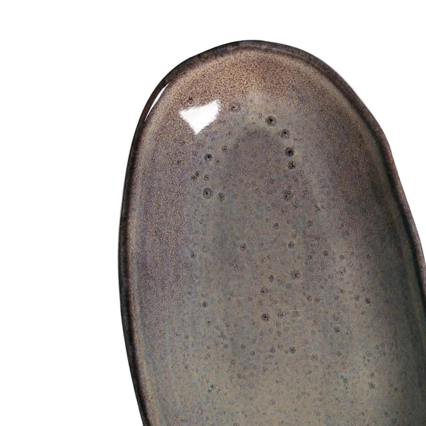 Ceramic dish with reactive glaze on a white background