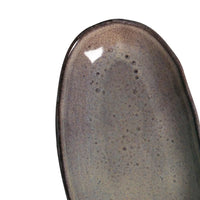 Ceramic dish with reactive glaze on a white background