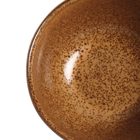 Brown ceramic plate with reactive glaze on a white background