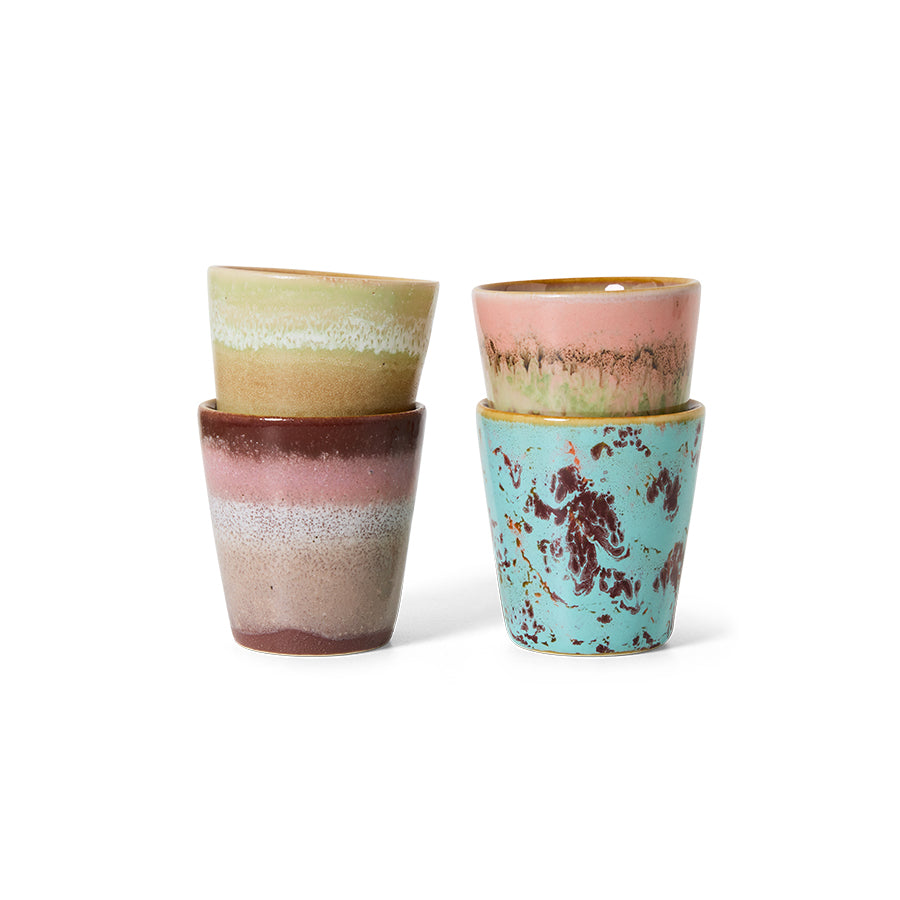 Set of four ceramic cups with multicolored glaze on a white background