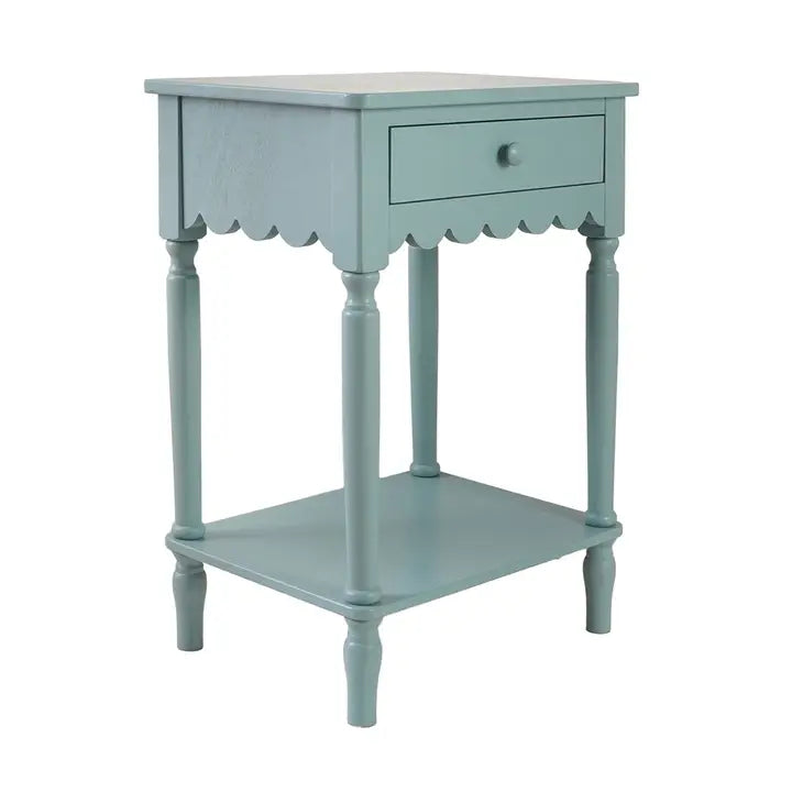 A small painted wooden side table with a single drawer, scalloped apron, turned legs, and a lower shelf, shown on a plain white background.