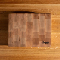 A rectangular wooden cutting board with a block-patterned design and a black 'LeBoeuf' logo in the bottom right corner, placed on a matching wooden surface.