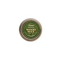 A round tin of Scotsman Unscented Wood Wax, featuring a green and gold label, set against a solid beige background.