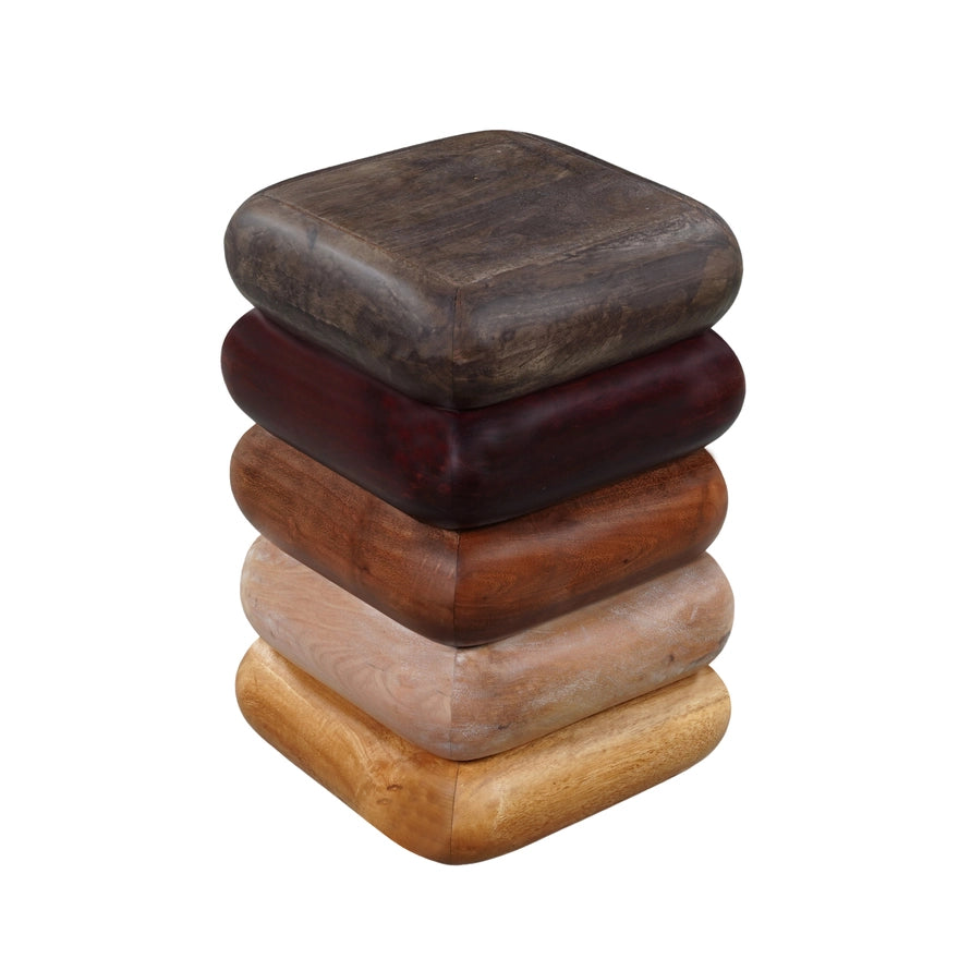 Stack of wooden stools with different finishes on a white background