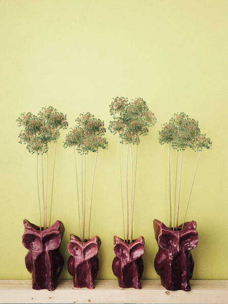 2 sizes purple owl vases with flowers and a yellow background