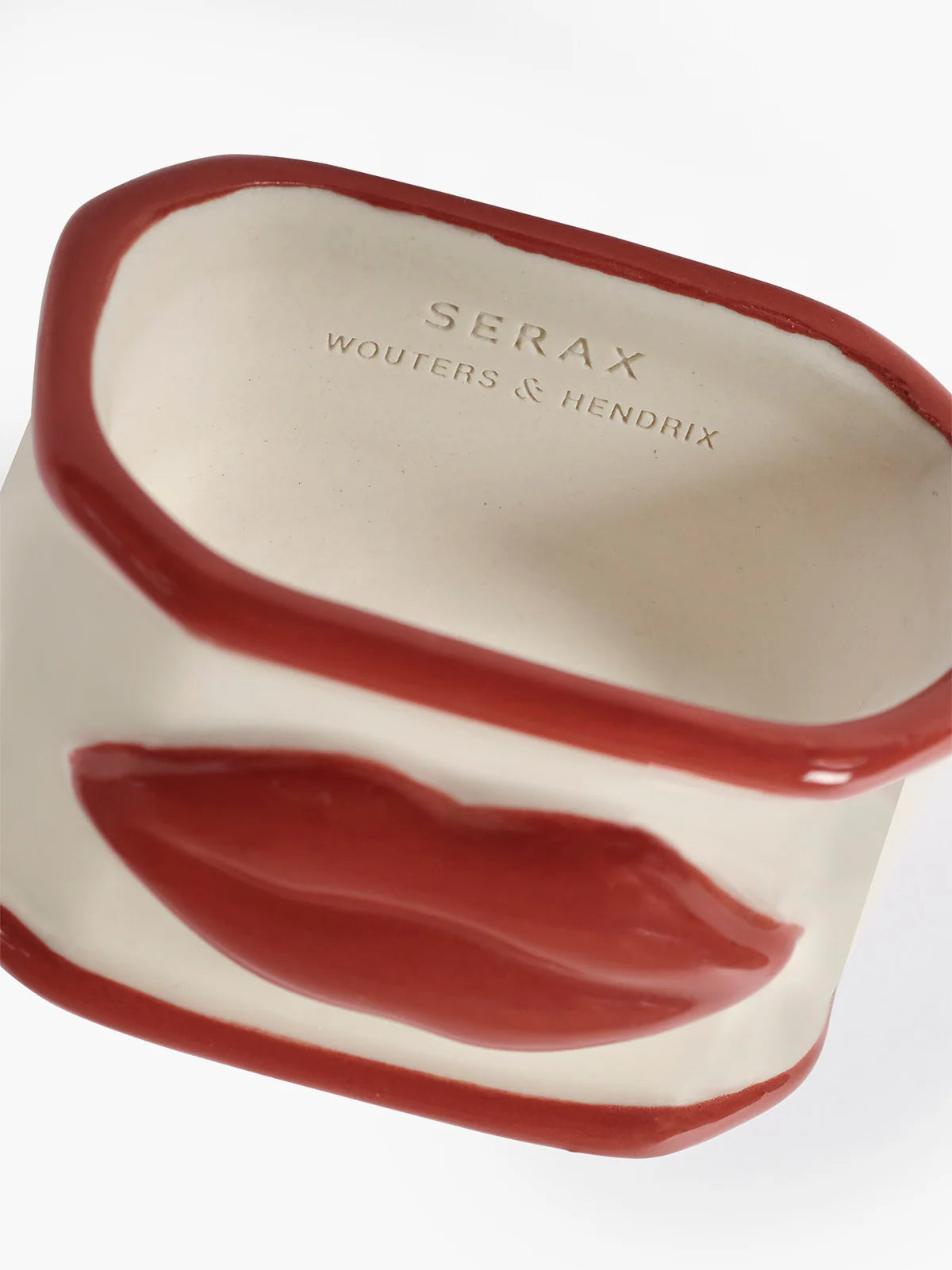 Ceramic napkin ring with red interior and exterior, featuring 'Serax' branding.
