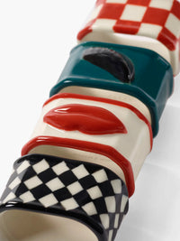 Colorful ceramic napkin rings  with checkered pattern on a white background