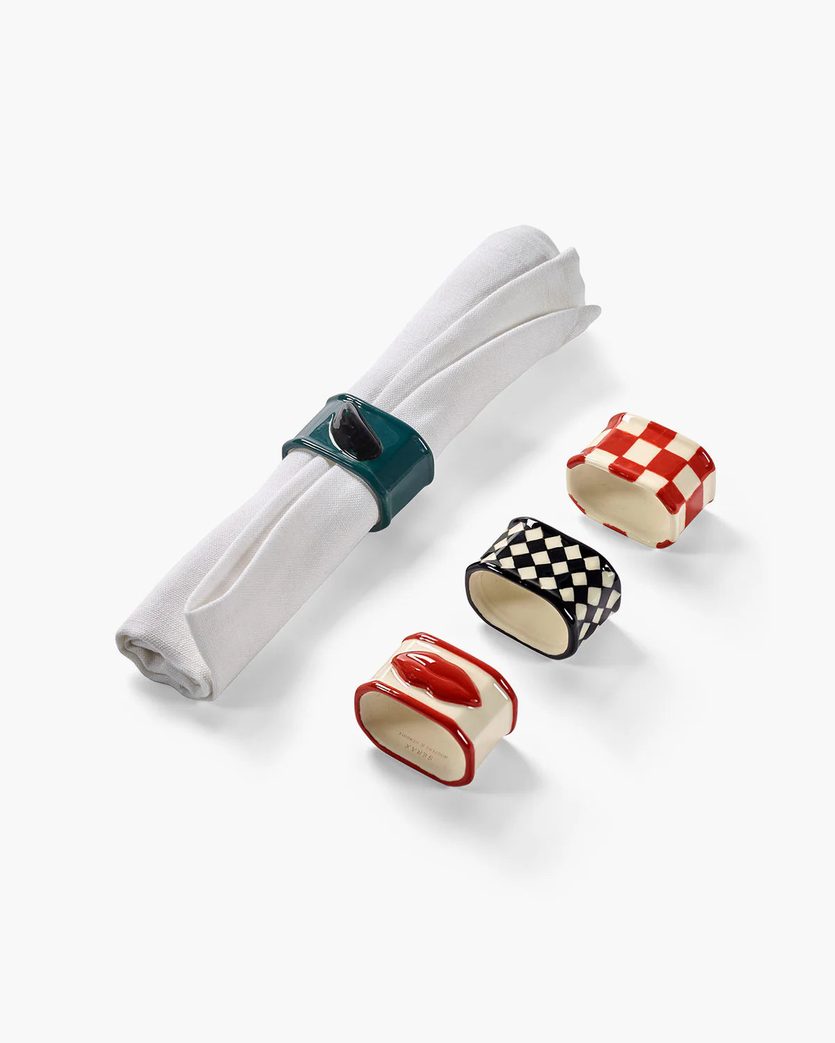 Set of napkin rings and napkin on white background