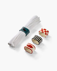 Set of napkin rings and napkin on white background