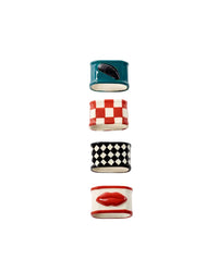 Set of four colorful ceramic napkin rings with patterned designs on a white background