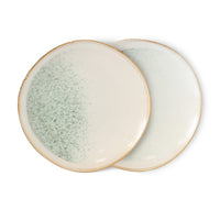 two ceramic side plates in light colors on white background