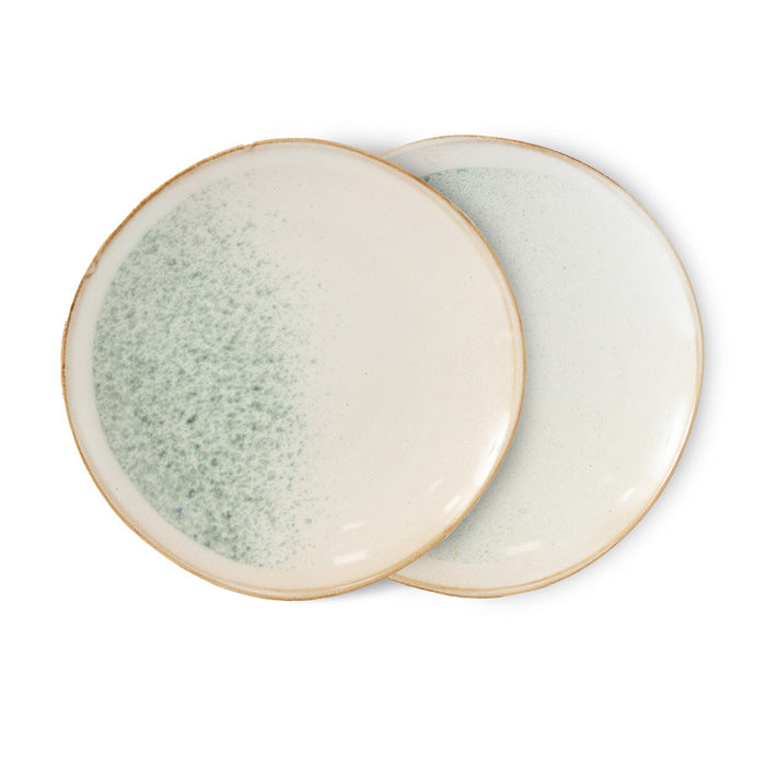 two ceramic side plates in light colors on white background