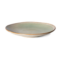 soft toned ceramic side plate on white background