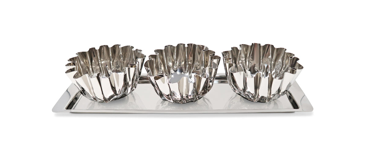 Set of three silver fluted bowls on a tray with a white background