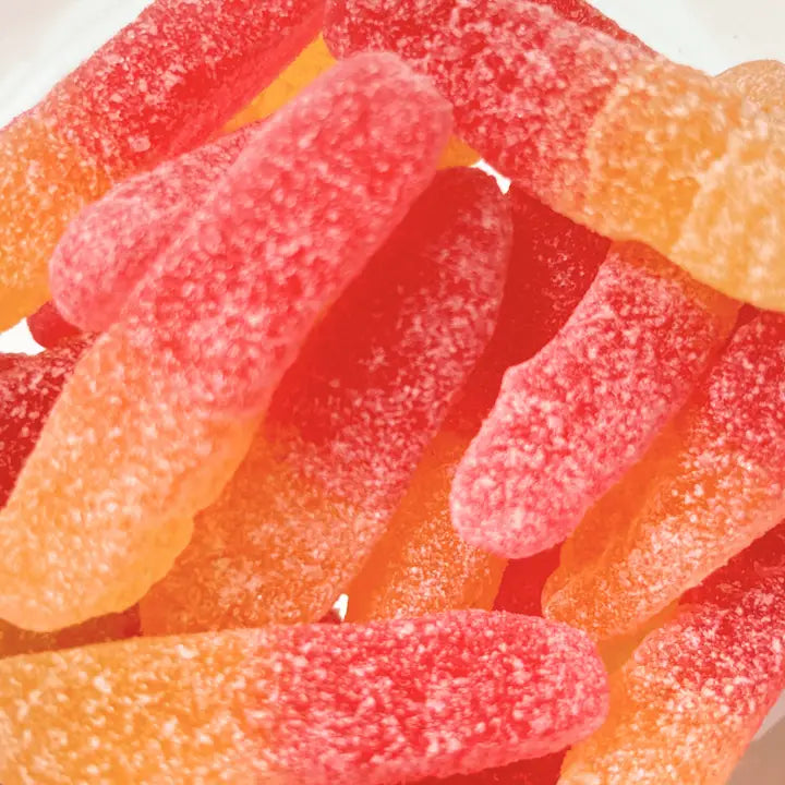 Close-up of colorful gummy worms on a white background