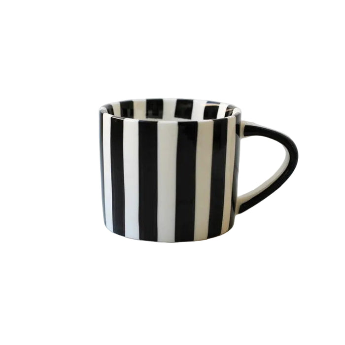 Black and white striped mug on a marble surface