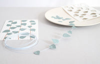 card with pre-punched leaves and metal wire on grey surface