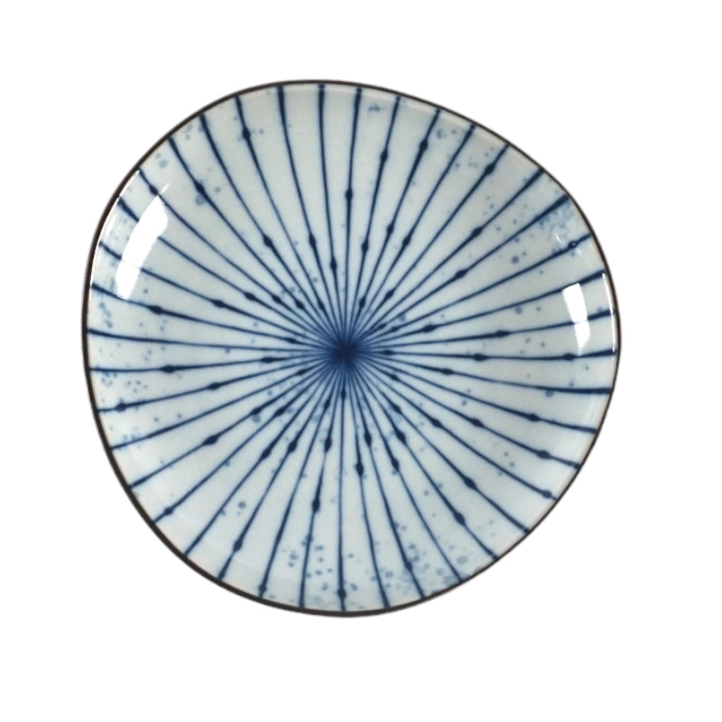 Ceramic plate with blue radial pattern on a white background