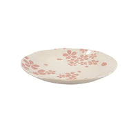 Ceramic plate with pink floral pattern on a white background
