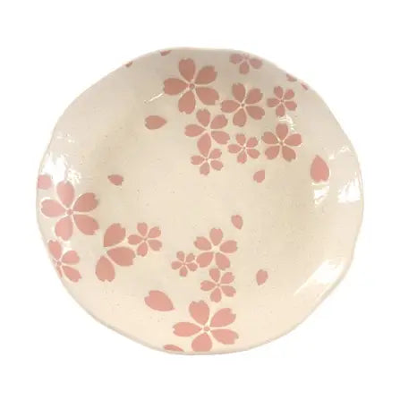 Round ceramic plate with pink floral pattern on a white background