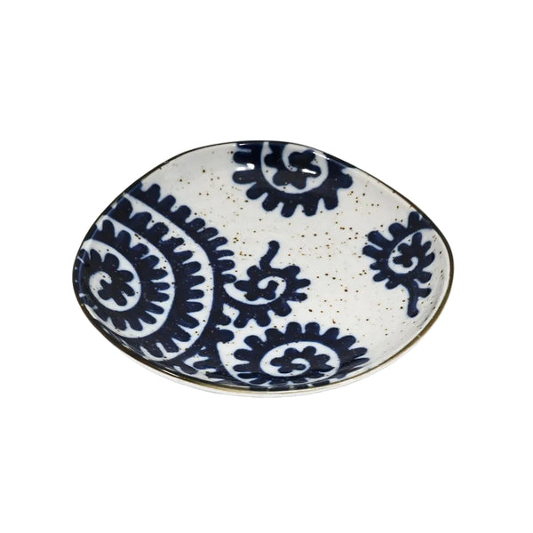 Ceramic plate with blue and white pattern on a white background