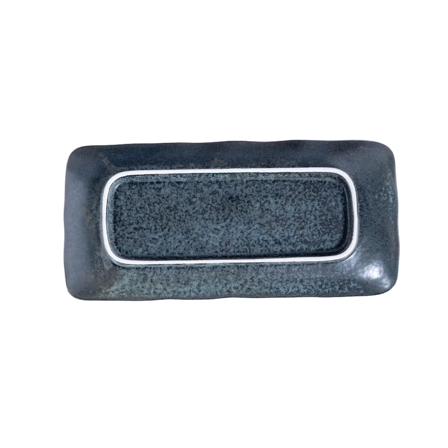 back side of a rectangular platter with black, speckled glaze