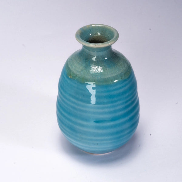 Turquoise ceramic vase on a white background