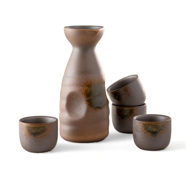 Set of brown ceramic vessels including a bottle and four cups on a white background