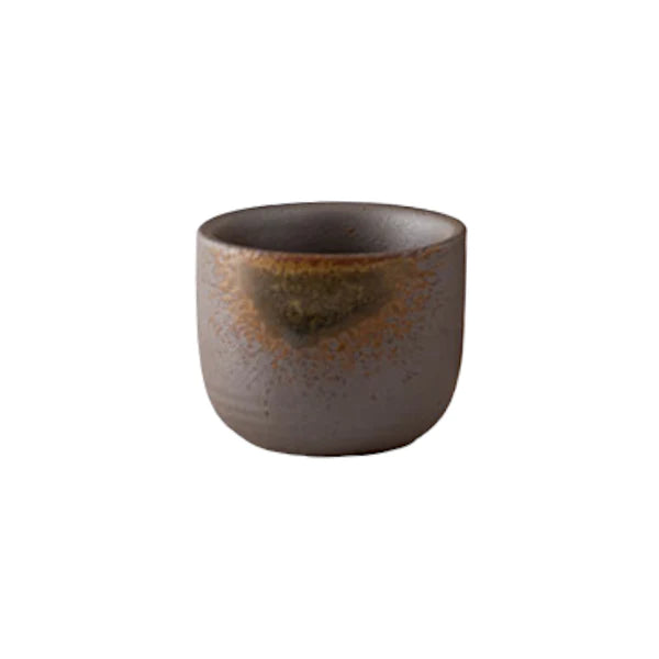 Ceramic cup with brown speckled glaze on a white background