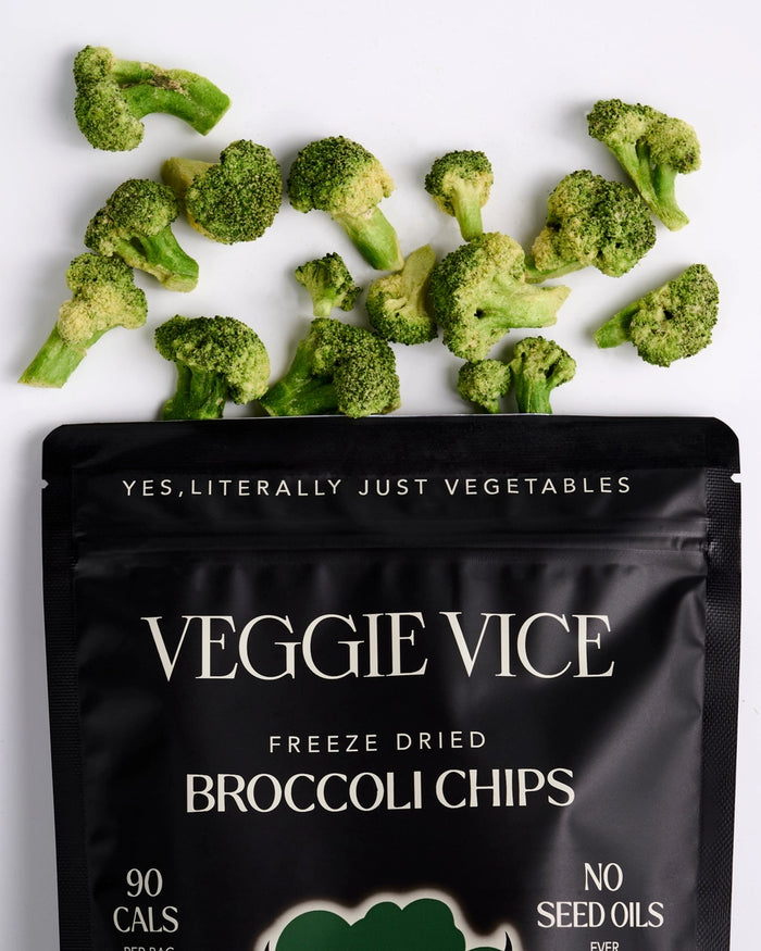 Veggie Vice freeze-dried broccoli chips packaging with scattered broccoli pieces on a white background