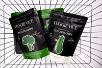 Three packages of Veggie Vice freeze-dried vegetable chips on a grid background