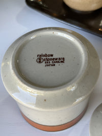 Ceramic product with 'rainbow Stoneware' branding on a white surface