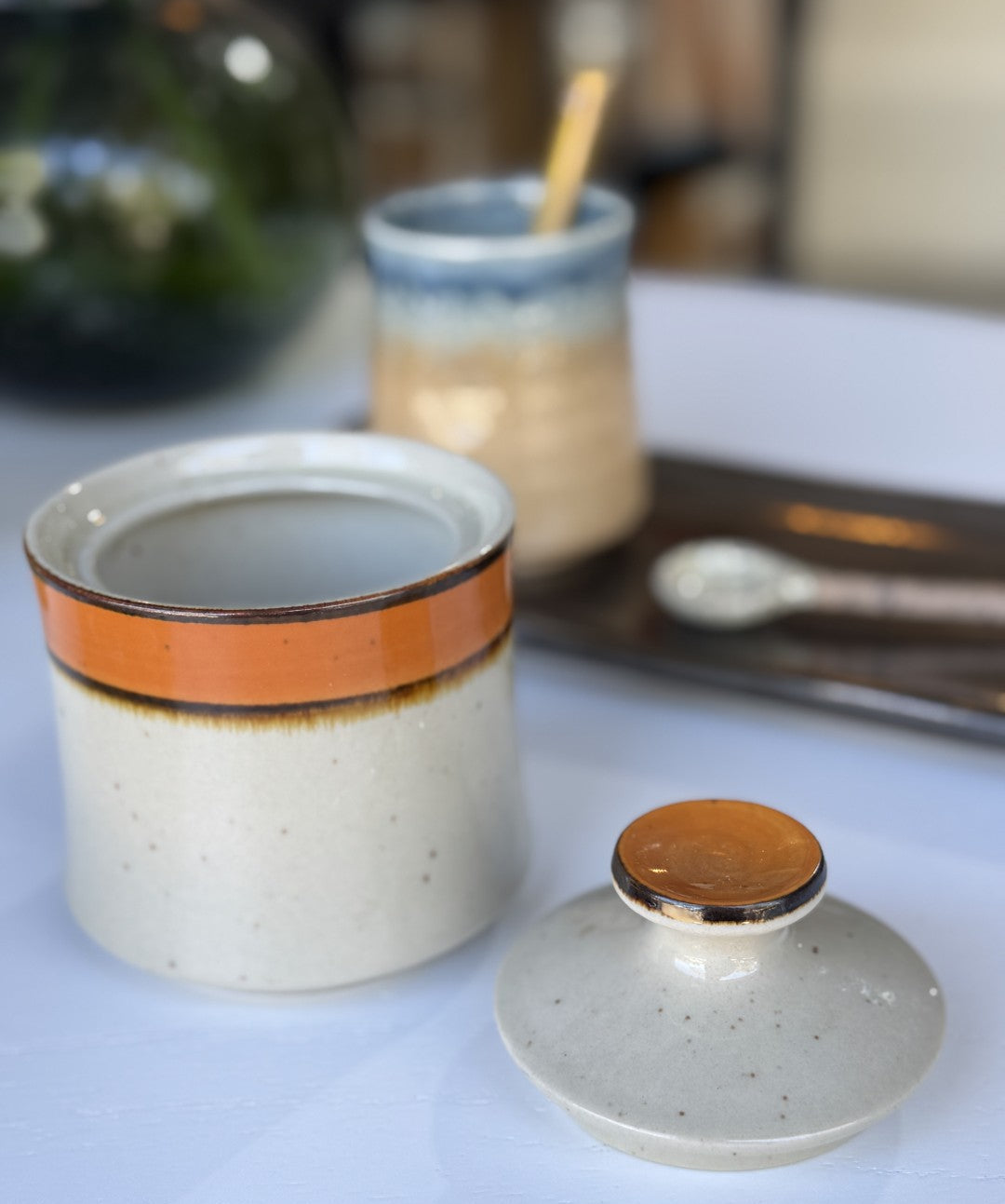 Ceramic jar with a lid on a light surface