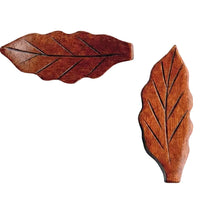 Two wooden leaf-shaped stamps on a white background