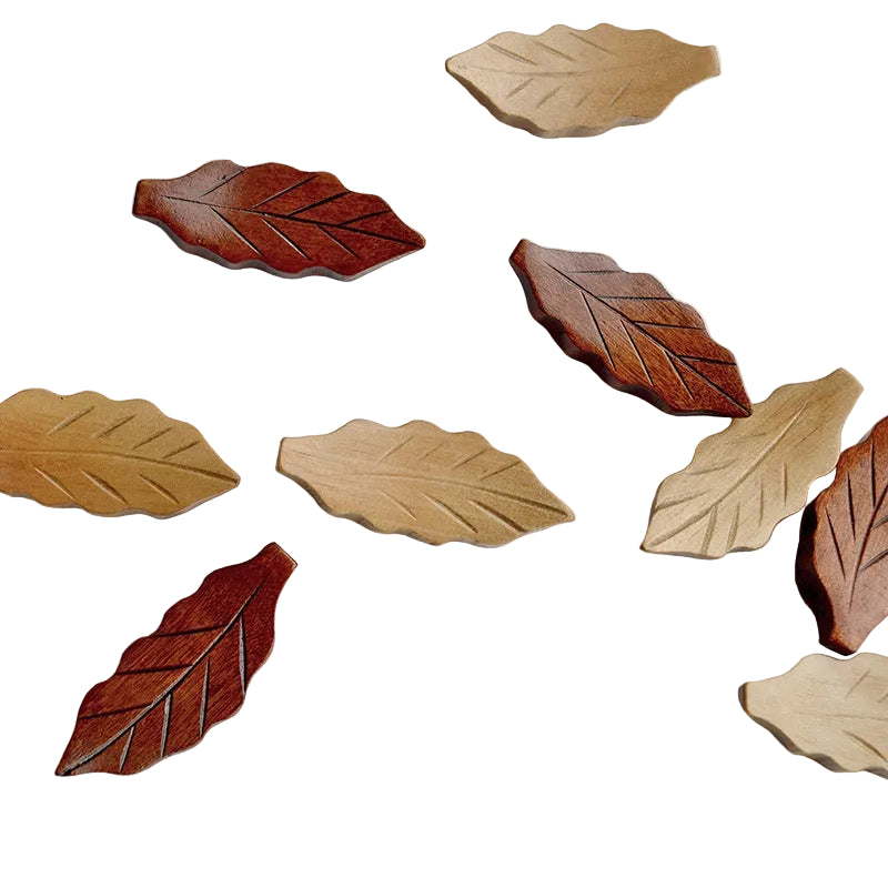 Wooden leaf-shaped coasters in various shades of brown on a white background