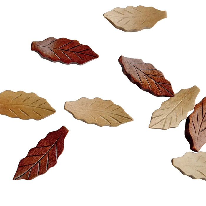 Wooden leaf-shaped coasters in various shades of brown on a white background