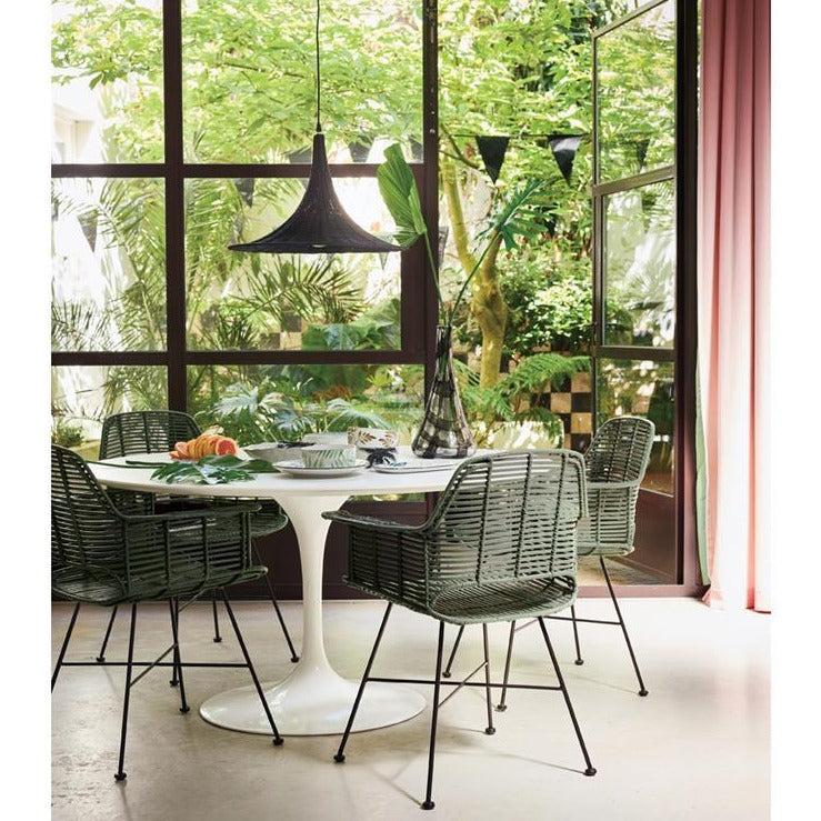 round table with green chairs and jungle ceramics 