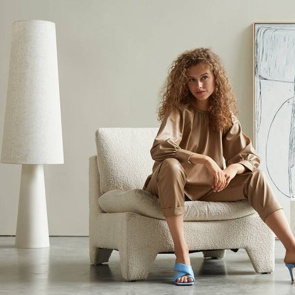 retro lounche chair with lady who wears blue shoes