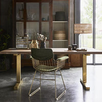 brass metal wire chair with arm rests and table