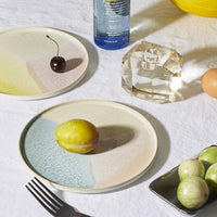 table setting with pastel colored plates