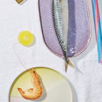 shrimp on a round pastel colored plate